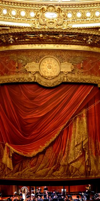 Opera stage with curtains closed and orchestra 
